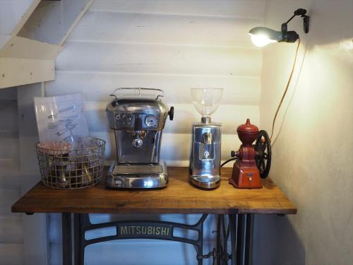 a table with a coffee maker and a blender on it at Minanonno Play Village in Yoichi