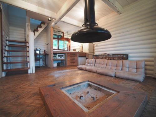 a living room with a couch and a table at Minanonno Play Village in Yoichi