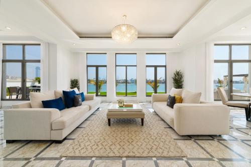 a living room with two couches and a table at Maison Privee - Luxury Villa with Dramatic View Private Beach & Pool in Dubai