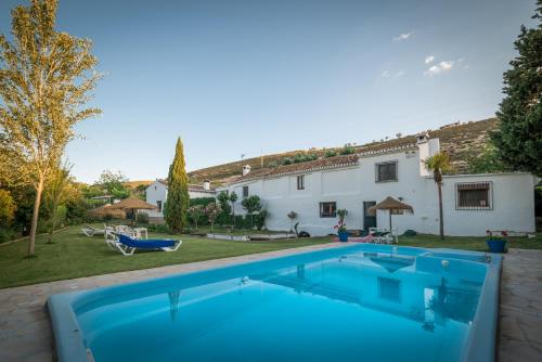 a villa with a swimming pool and a house at Al Agia - Los Molinos de Padul in Padul