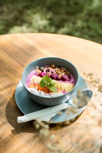 a bowl of food sitting on a plate on a table at Suku Lifestyle Hotel & Villas in Selong Belanak