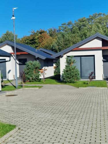 a house with a brick driveway in front of it at Jastrzębia Port in Jastrzębia Góra