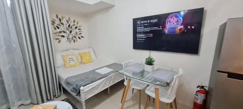a small room with a table with a laptop on it at Inspiria Condo Units beside Abreeza Mall Davao in Davao City