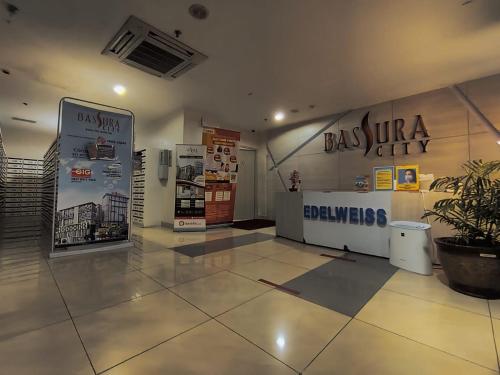 a large room with a lobby with a sign that says baja supreme court at Toptravel Bassura City in Jakarta