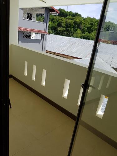 a balcony with a view of a building at Hotel Larensia in Labuan Bajo