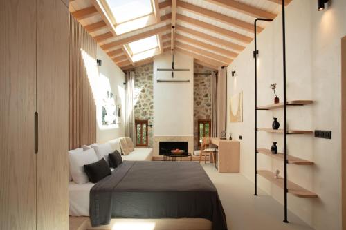 a bedroom with a bed and a fireplace at Ultava Houses in Datca