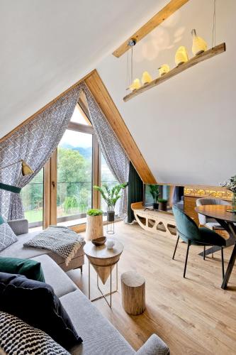 a living room with a couch and a table at Rezydencja Górska, Odkryj-Zakopane in Zakopane