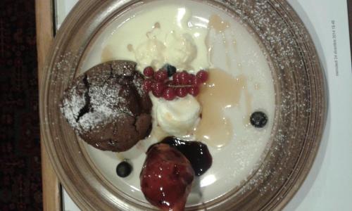 a plate of dessert with berries and ice cream at Hotel Etoile De Neige in Valtournenche