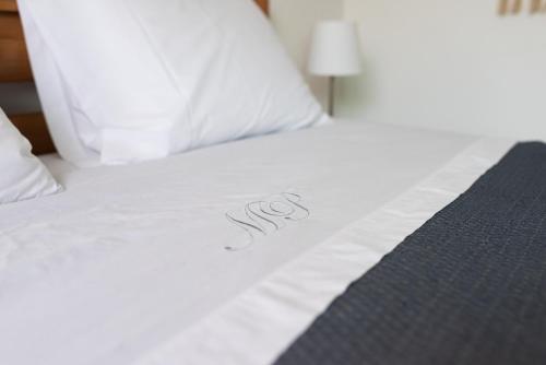 a white bed with the word spa written on it at River 9 and City View Porto Gaia by MP in Vila Nova de Gaia
