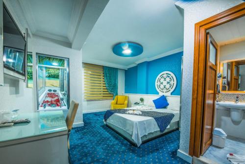 a hotel room with a bed and a bathroom at Kar Hotel in Mersin