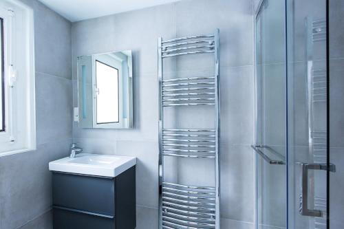 a bathroom with a shower and a sink and a mirror at Chalet Chintalaya in Chamonix-Mont-Blanc