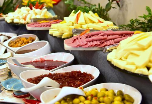a table with different types of cheese and other foods at GRAND KÖSE AİRPORT HOTEL in Ortaca