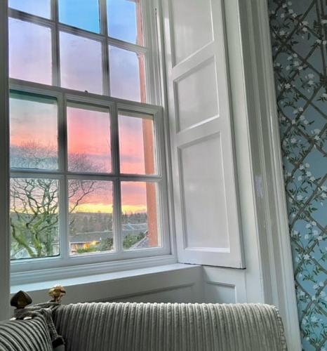 a window in a room with a couch looking out at Moffat House in Moffat