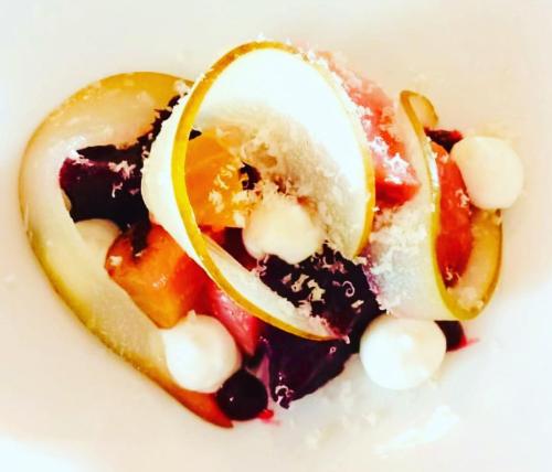 a dessert with fruit on a white plate at Moffat House in Moffat