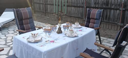 a table with a white table cloth and wine glasses at Iasskii Torg - La belle epoque in Iaşi