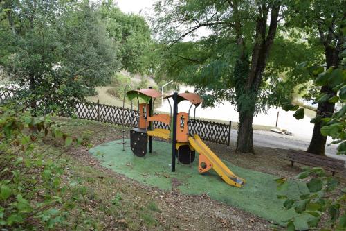 a playground in a park with a play equipment at location maison à Cajarc 46160 (Lot) in Cajarc