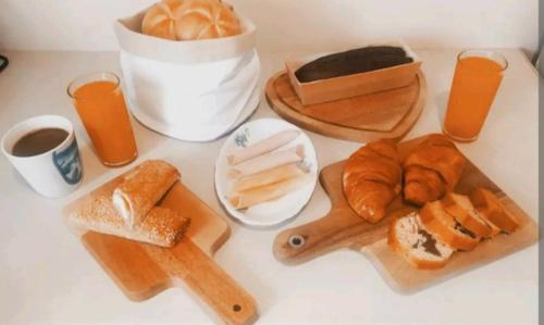 a table with a bunch of bread and orange juice at Havenly Loft in Mytilene