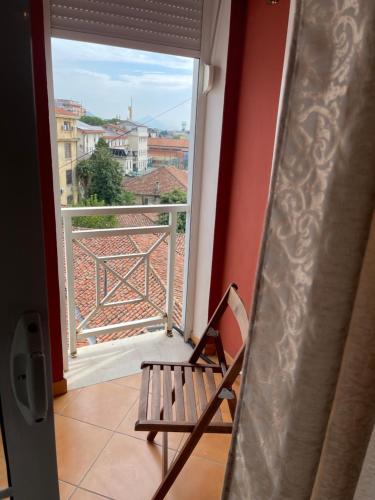 a room with a balcony with a bench and a window at Pedestrian Street Center Apartment in Shkodër