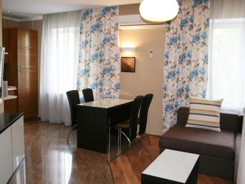 a kitchen and living room with a table and chairs at Aparthotel in Chişinău