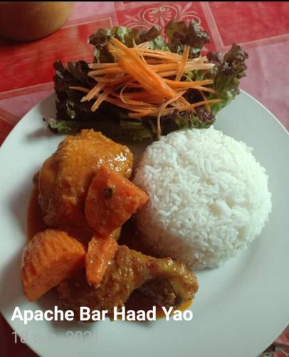 a white plate of food with rice and vegetables at Apache Bar Haad yao in Haad Yao