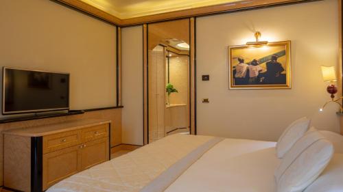 a hotel room with a bed and a television at Mulino Luxury Boutique Hotel in Buje