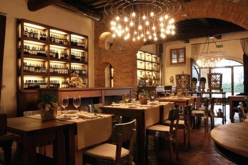 a restaurant with tables and chairs and a chandelier at Hotel 500 Firenze in Campi Bisenzio