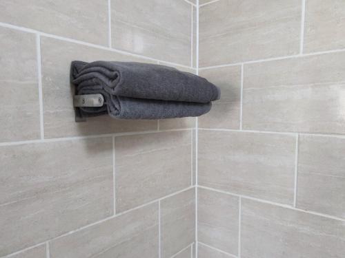 a bathroom with a towel on a tiled wall at 3 BEDROOM FLAT IN CENTRAL LONDON - REGENTS PARK / BAKER ST in London