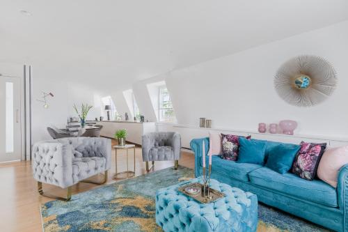 a living room with a blue couch and chairs at 1st Class Covent Garden Residences for 1st Class Guests in London