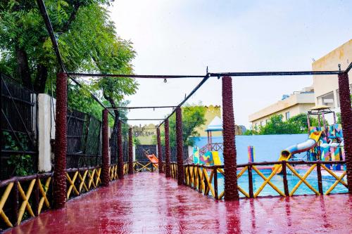 a water park in the rain with a playground at Swad Ri Dhani, Ajmer in Ajmer