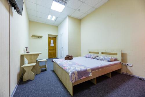 a room with a bed and a desk in it at Mini Hotel near Arena City in Kyiv