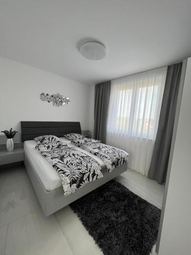 a bedroom with a bed and a window at MY PLACE in Slavonski Brod