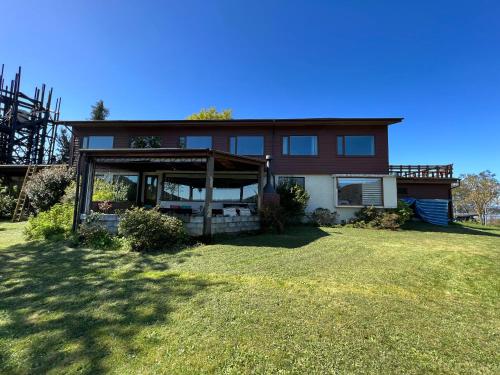 a house with a large yard in front of it at Hotel Boutique Cutipay in Valdivia