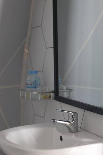 a bathroom sink with a mirror and a white sink at Adventure Dome Resort in Kep