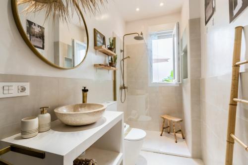 uma casa de banho com um lavatório e um espelho em Oasis con patio y encanto en centro Sevilla em Sevilha