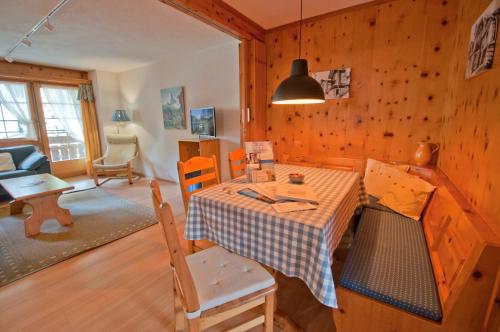 a kitchen and living room with a table and chairs at Dent Blanche in Zermatt