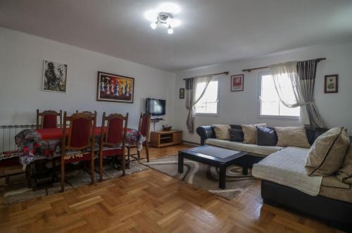 a living room with a couch and a table at Apartments Millenium in Žabljak