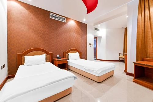 Postel nebo postele na pokoji v ubytování OYO 118 Revira Hotel