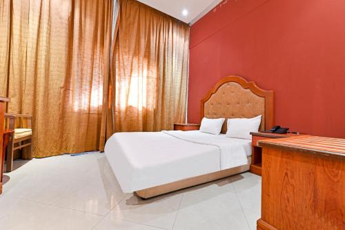 Postel nebo postele na pokoji v ubytování OYO 118 Revira Hotel