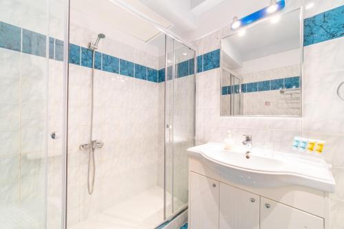 a bathroom with a shower and a sink at St Nicholas B8 Beach Studio I in Dafnila