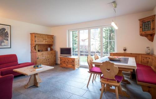 a living room with a red couch and a table at Haus Wick in Klosters Serneus