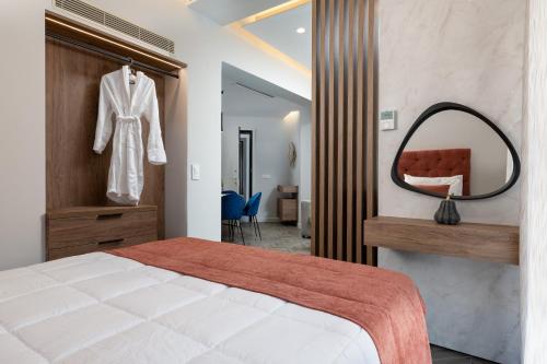 a bedroom with a large bed and a mirror at ANIMA DEL SOL (BASILICO) in Ixia