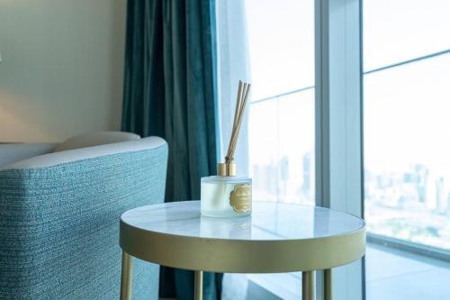 a table with a candle and chopsticks on it next to a window at Exquisite Apartment Minutes Away from the Beach in Dubai