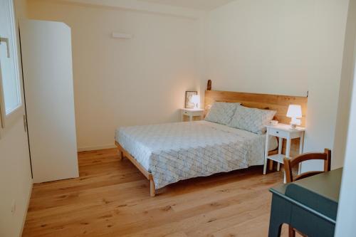a small bedroom with a bed and two tables at Casalloro in Valdagno