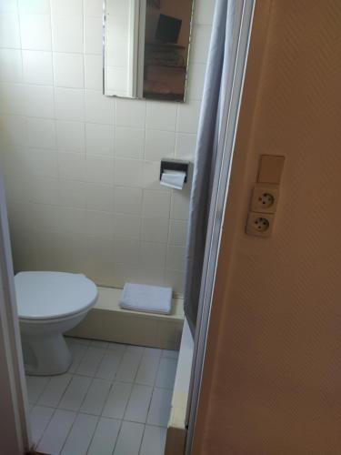 a bathroom with a toilet and a sink and a tub at Le Nouveau Monde in Breuillet