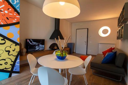 a dining room and living room with a table and chairs at Bocelli Guest House in Laiatico