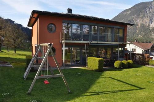 a house with a ladder in front of it at Ammann Marika in Vandans