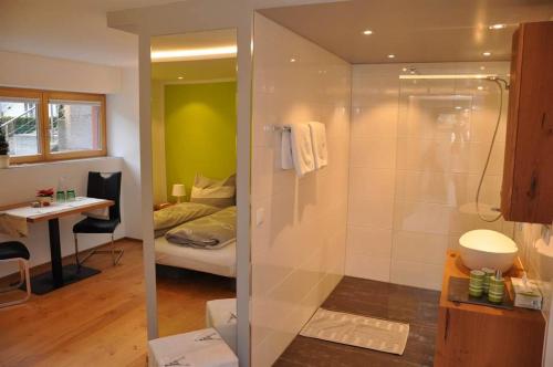 a bathroom with a shower and a bedroom at Ammann Marika in Vandans