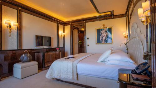 a bedroom with a large bed and a television at Mulino Luxury Boutique Hotel in Buje