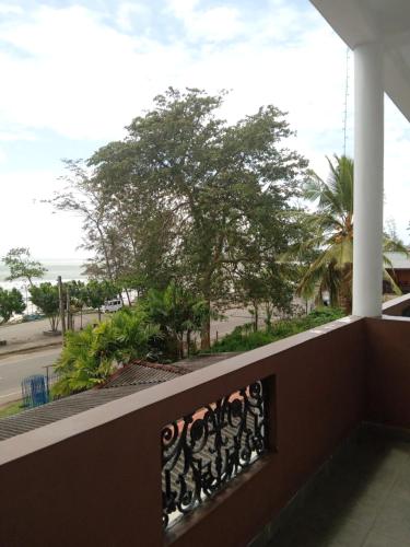 a balcony with a view of the beach at New Golden Bay Resort Weligama in Weligama