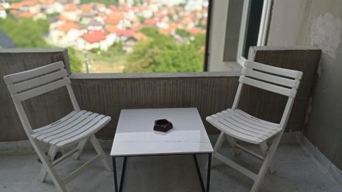 two chairs and a table with a piece of chocolate at Sleep and drive No5 in Sarajevo